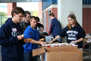 Stephanie Novak and Jordan Taylor serving hot dogs and snacks after the walk.